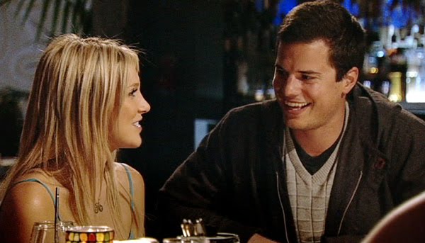Max Ritz smiling at a restaurant table with Stephanie Pratt in a television still