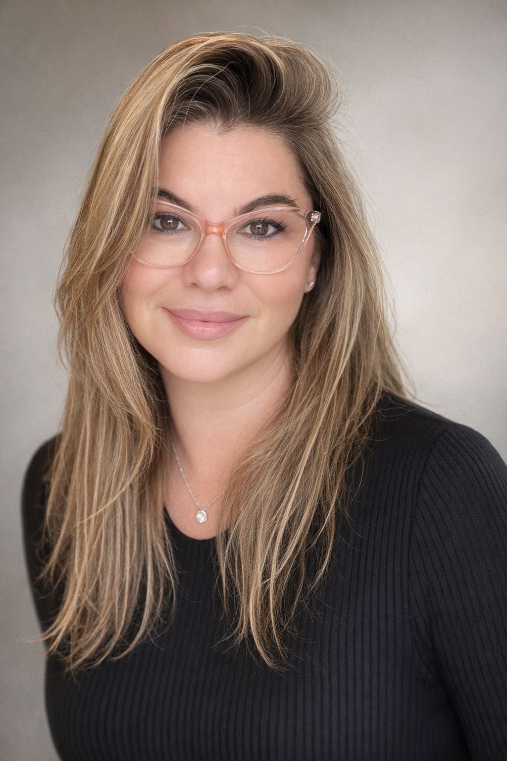 Maya Mason in a black top, photographed against a neutral background