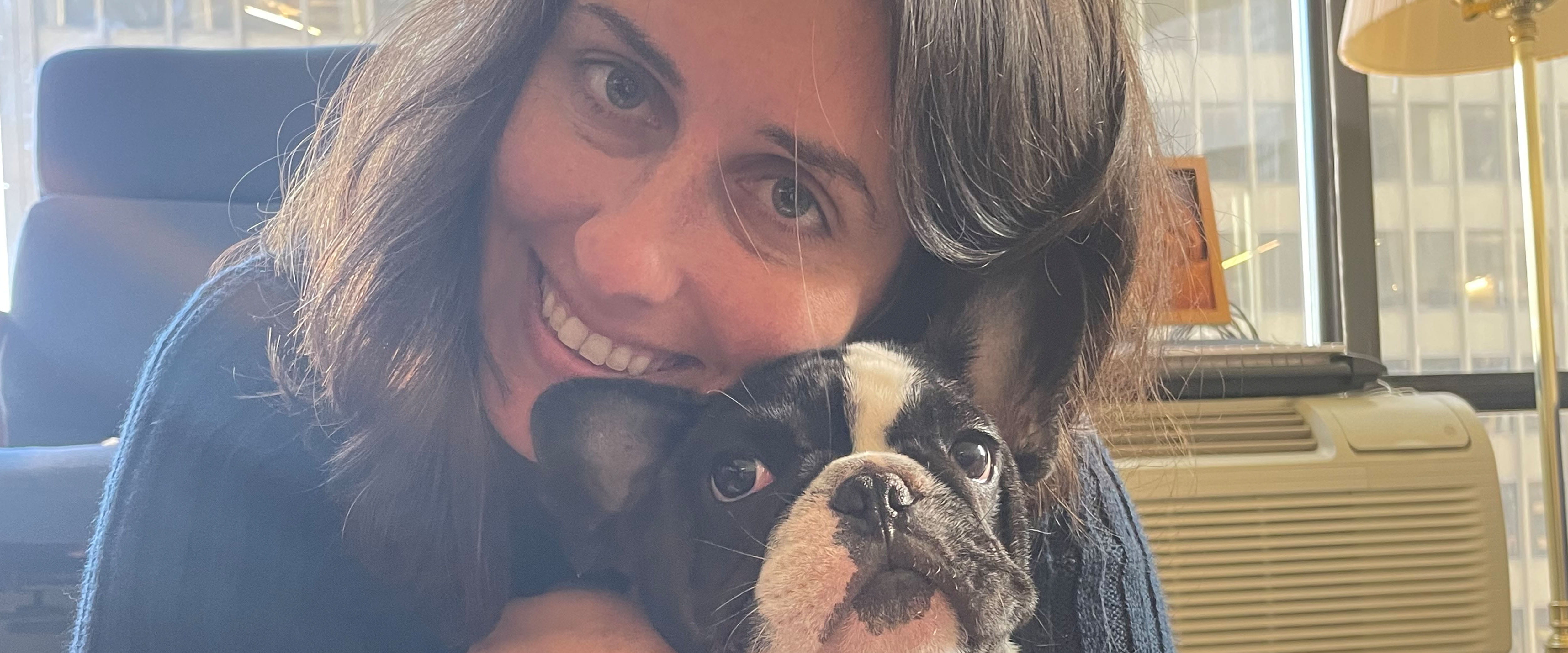 Maya Shaposhnik Cadena smiling beside her French bulldog Shor