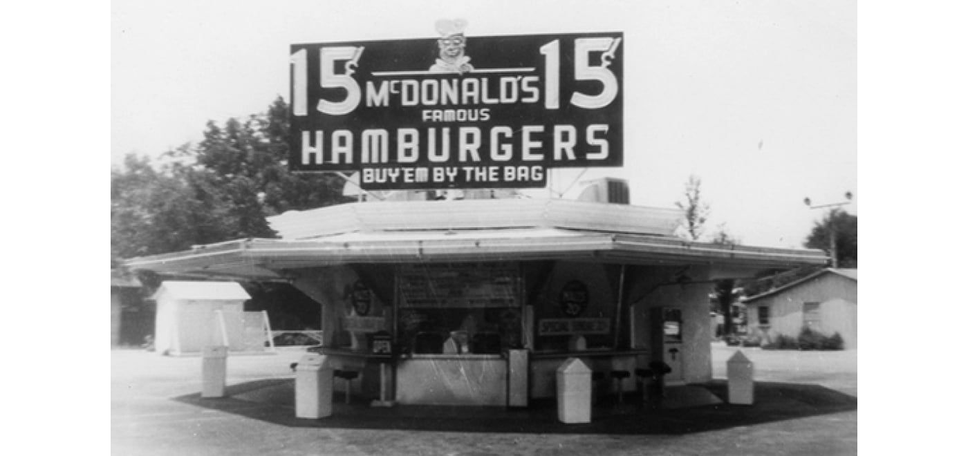 Archival photograph of the McDonald brothers’ San Bernardino restaurant with a 15-cent hamburger sign