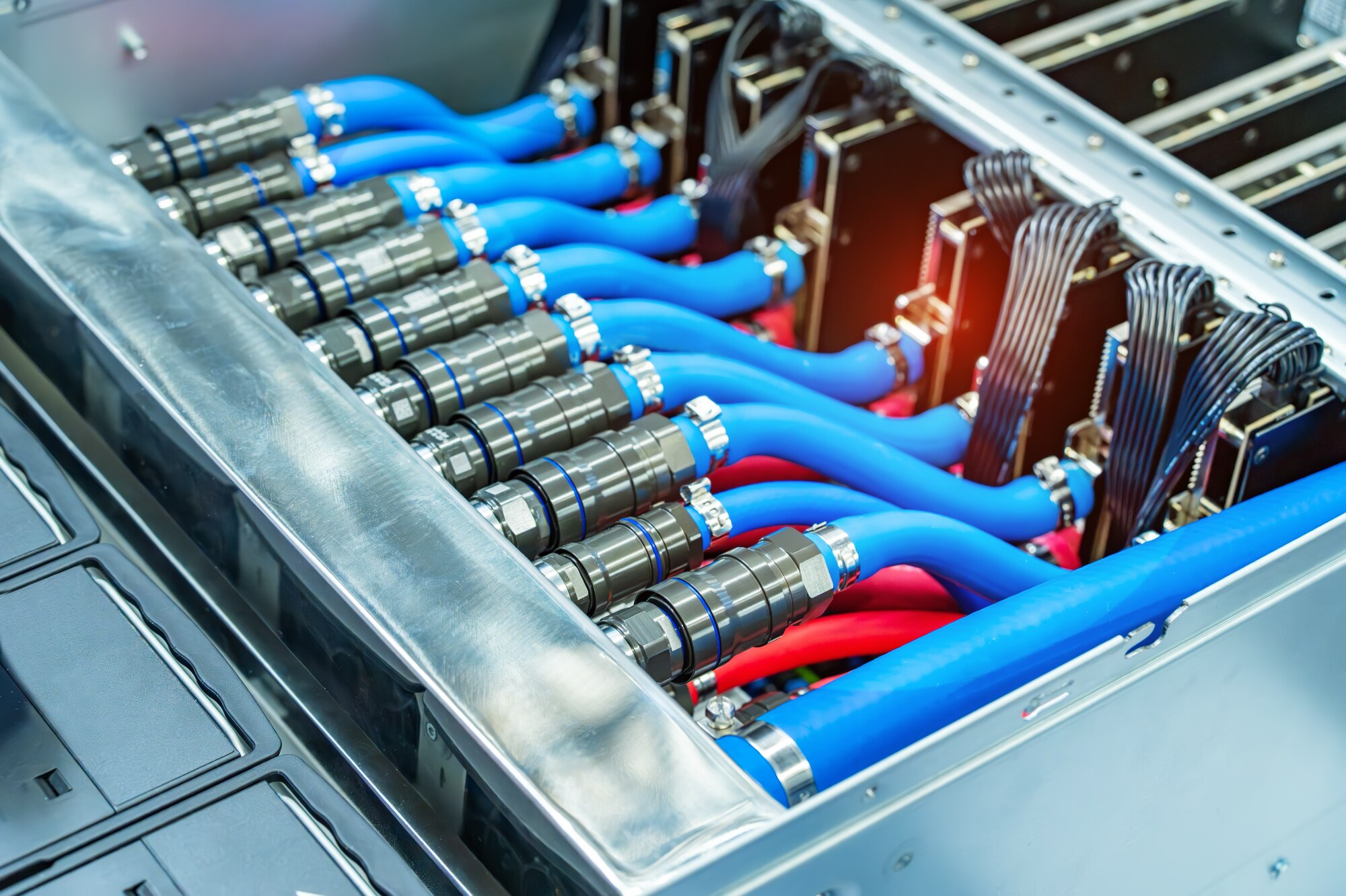 Blue and red liquid-cooling lines connected to high-density computing hardware