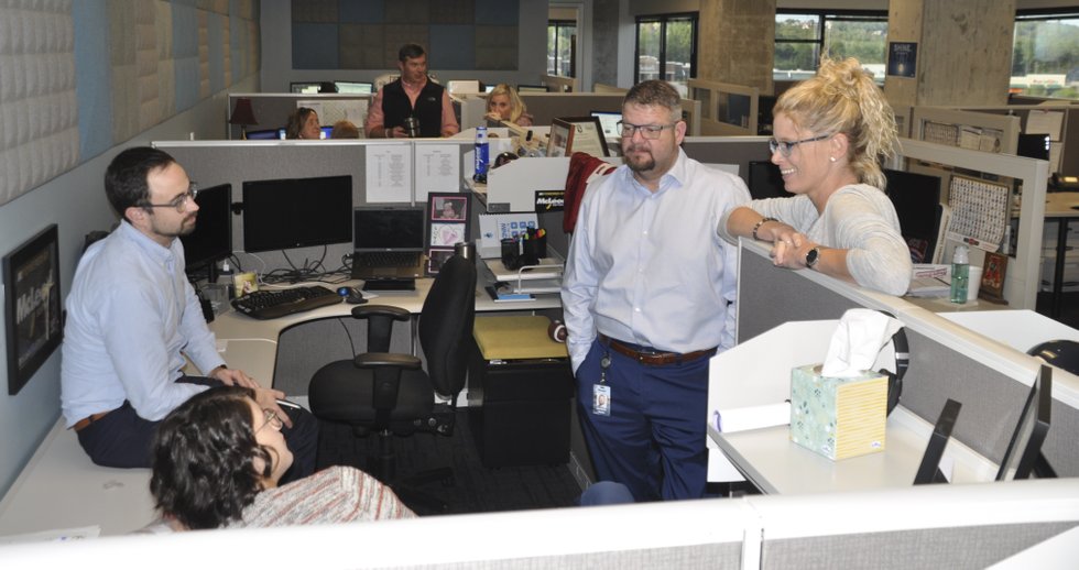 McLeod Software employees talking in the company's Birmingham office