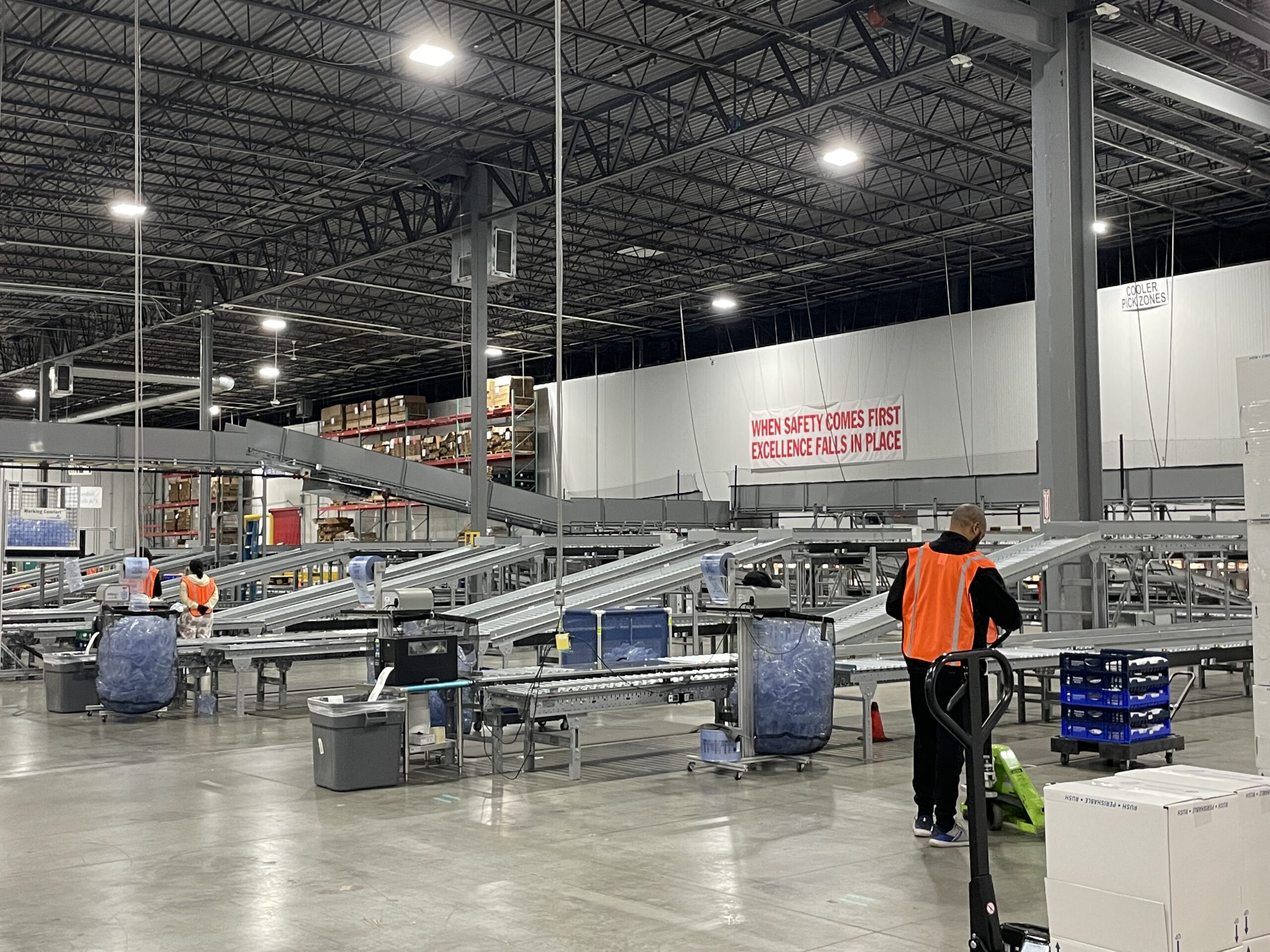 MD Logistics warehouse associates working among conveyor lines and pharmaceutical storage areas