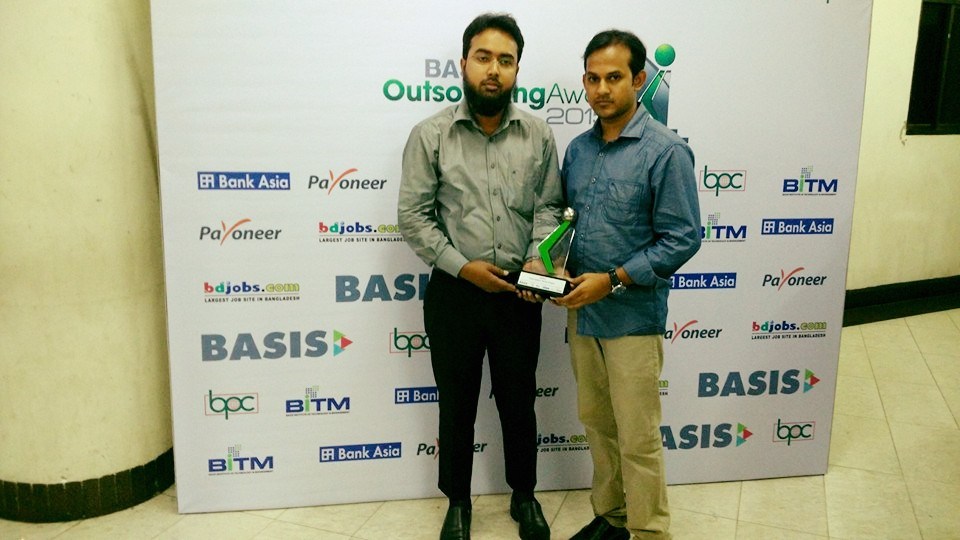 Nizam Uddin, left, and Tareq Hasan holding an award at the BASIS Outsourcing Award event