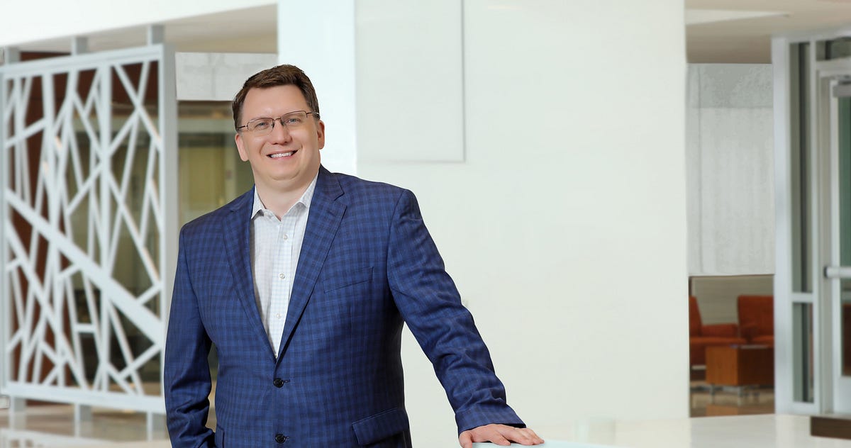Kenneth Young, president and CEO of Medecision, in a modern office