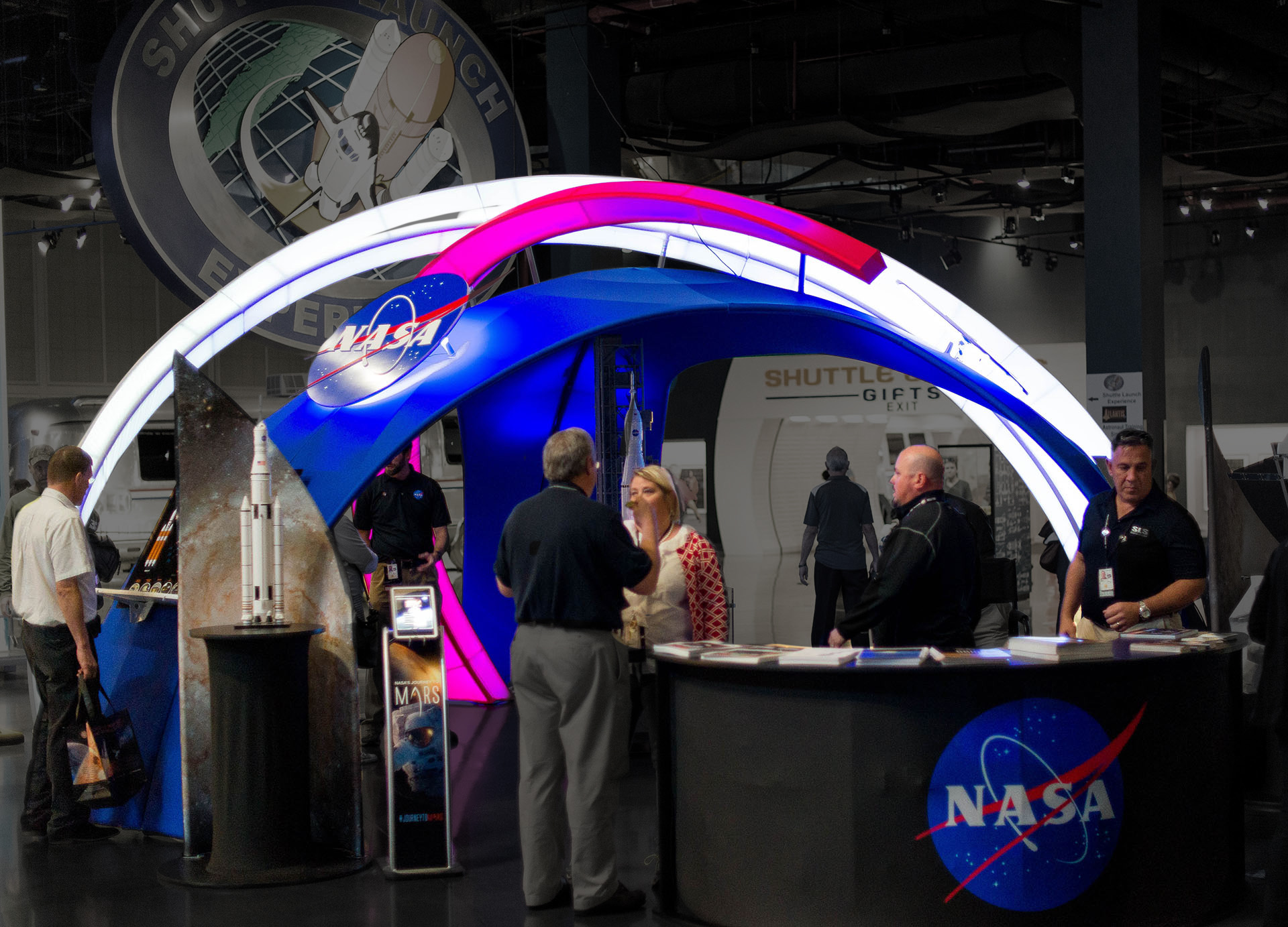 Visitors standing around a colorful NASA exhibit created by Media Fusion