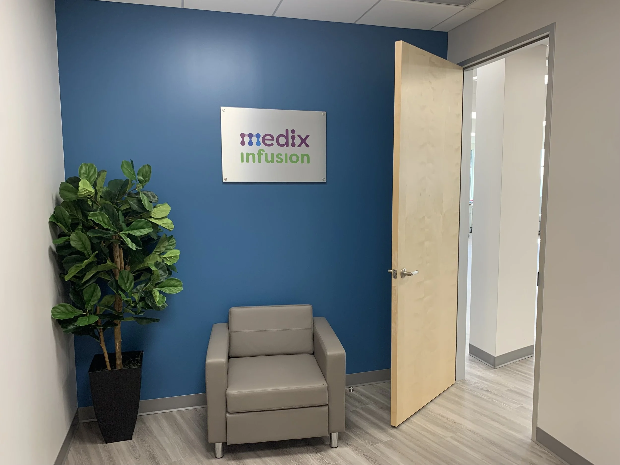 Medix Infusion clinic entrance with blue wall, plant, chair and open doorway