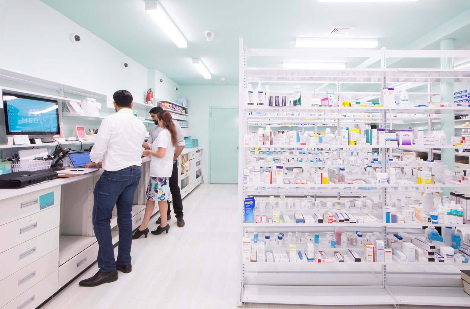 Inside a Medly pharmacy, with a counter and medication shelving