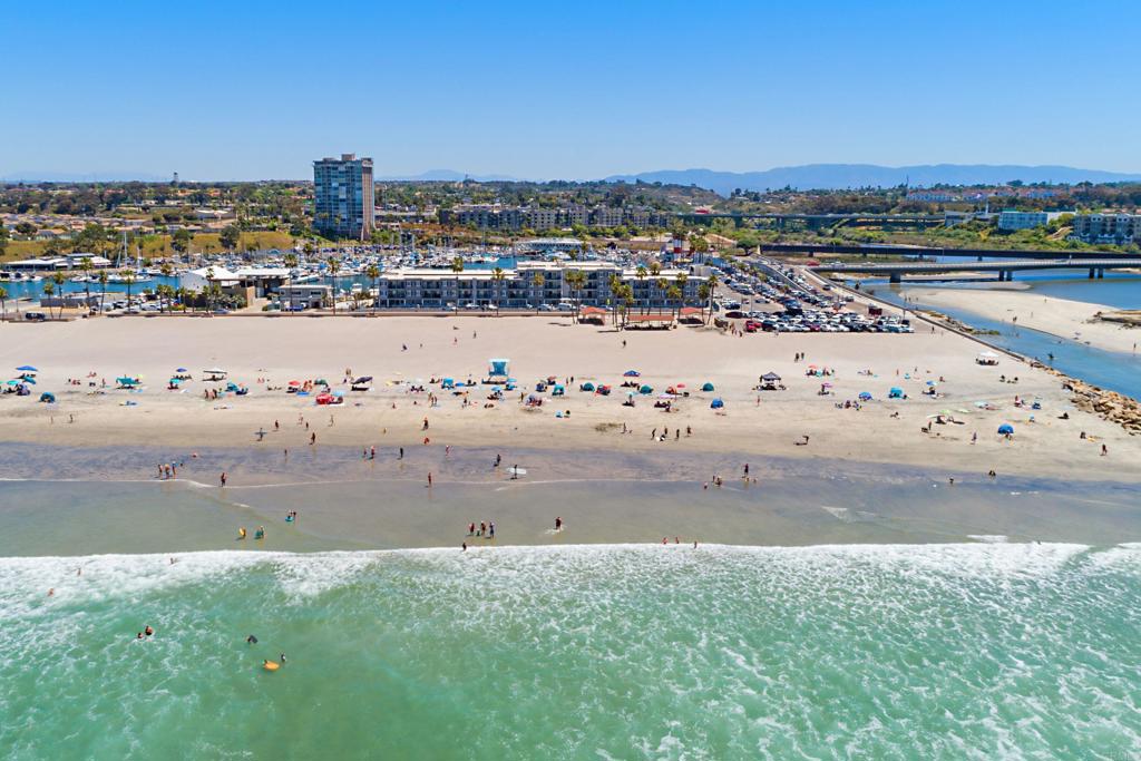 Aerial view of Oceanside beach with the harbor behind it