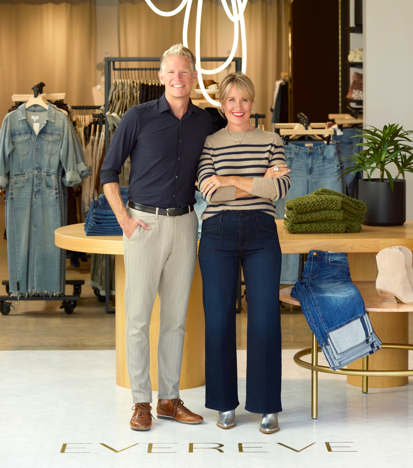Mike and Megan Tamte standing together inside an EVEREVE store, surrounded by clothing displays