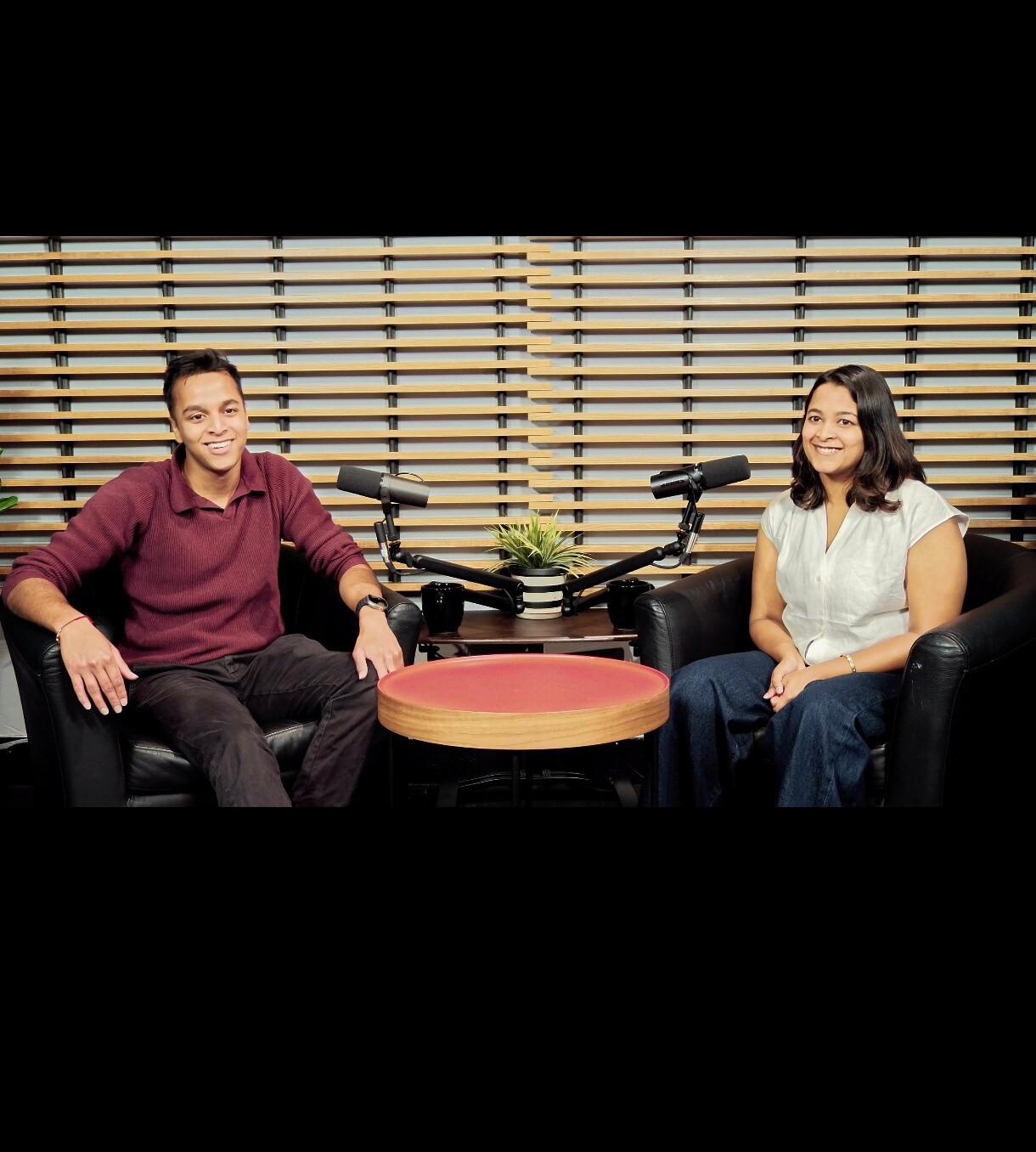 Mehul Agarwal and Gauri Agarwal seated in a studio with microphones