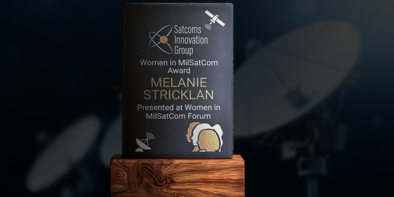 The 2025 Women in MilSatCom award engraved with Melanie Stricklan’s name.