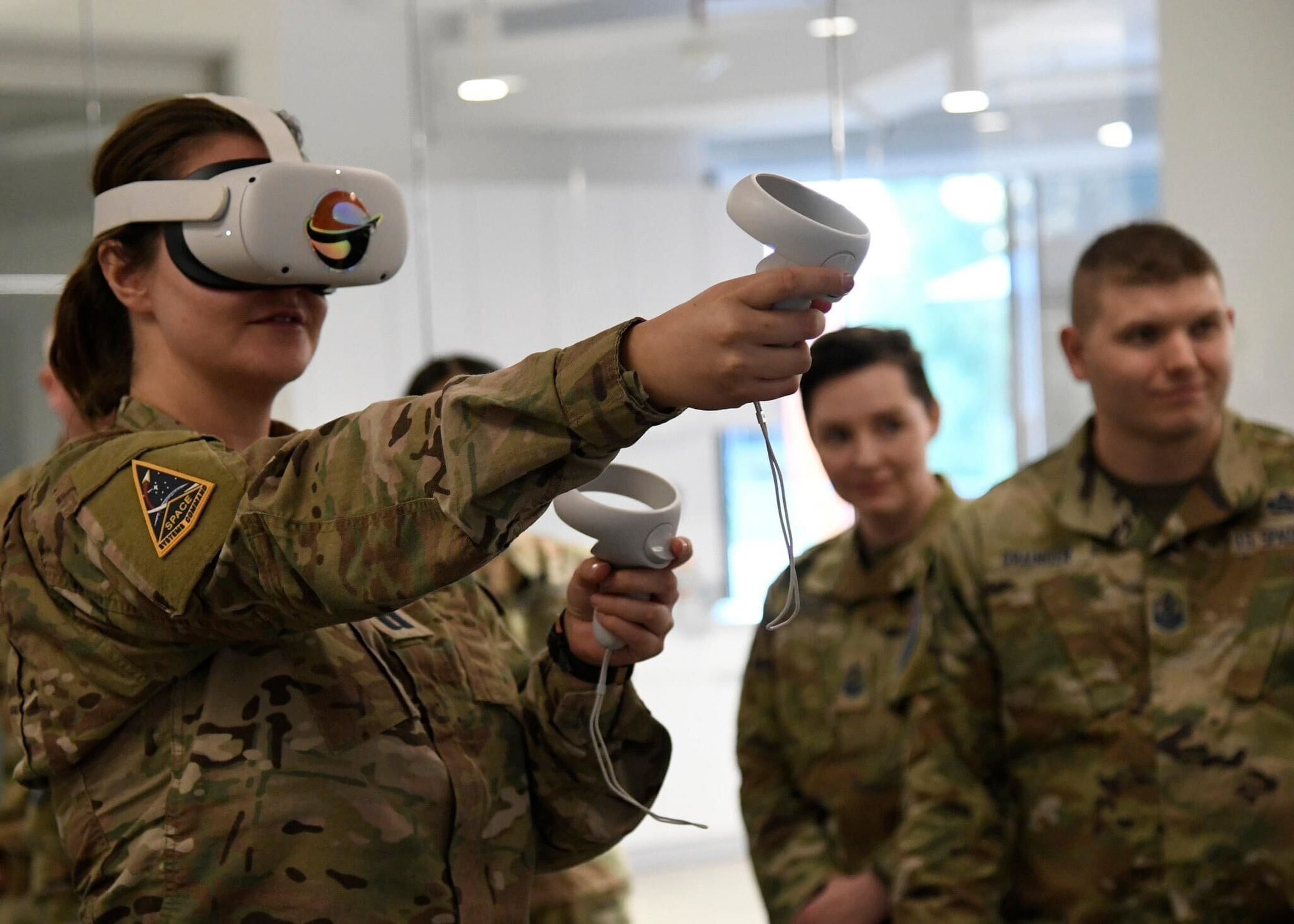 U.S. Space Force Guardians exploring astrodynamics with a virtual-reality headset and controllers.