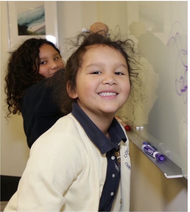 Chang’s daughters visiting her office and drawing on a whiteboard