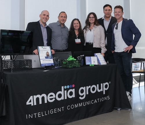 Six 4media group colleagues at an event stand; Melissa Elsner is fourth from the left