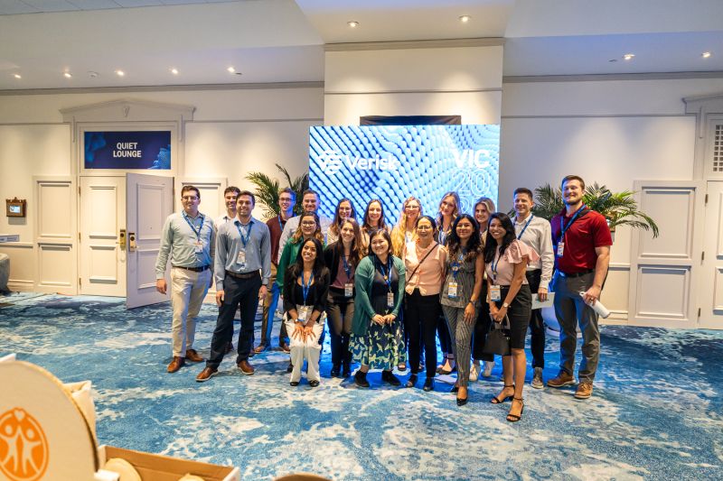 A group of Verisk Insurance Conference attendees posing together at the 2025 event