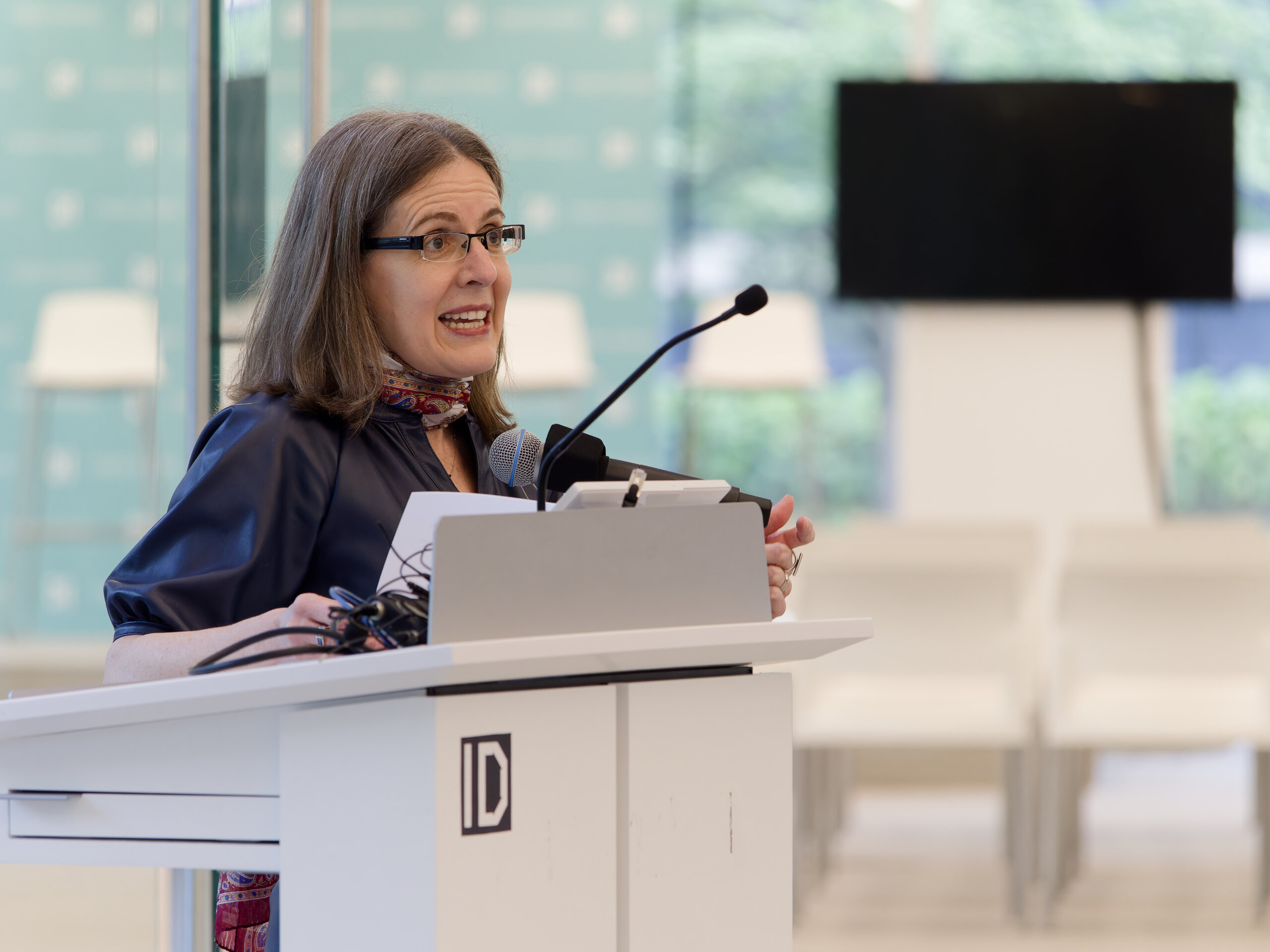 Melody Roberts speaking at a lectern during the Institute of Design's 2024 End of Year Celebration