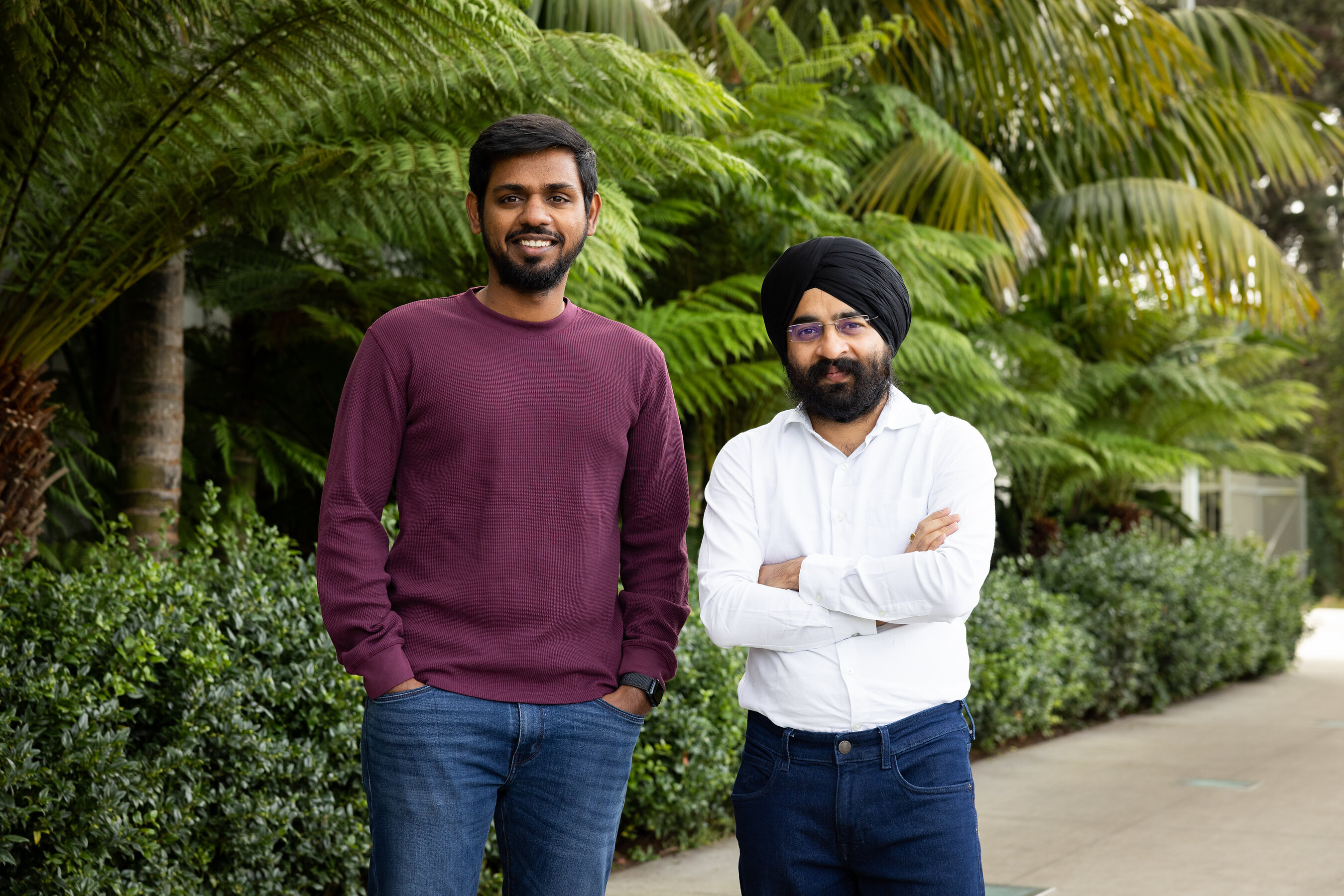 Mem0 co-founders Deshraj Yadav, left, and Taranjeet Singh, right, standing beside greenery