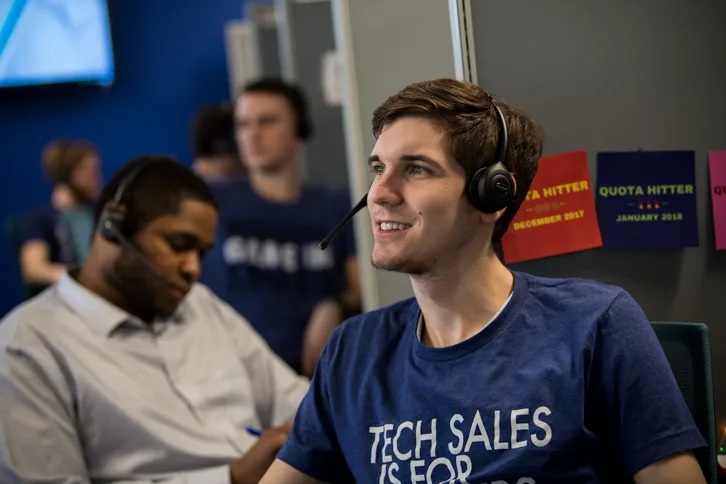 Sales representatives wearing headsets in a memoryBlue office