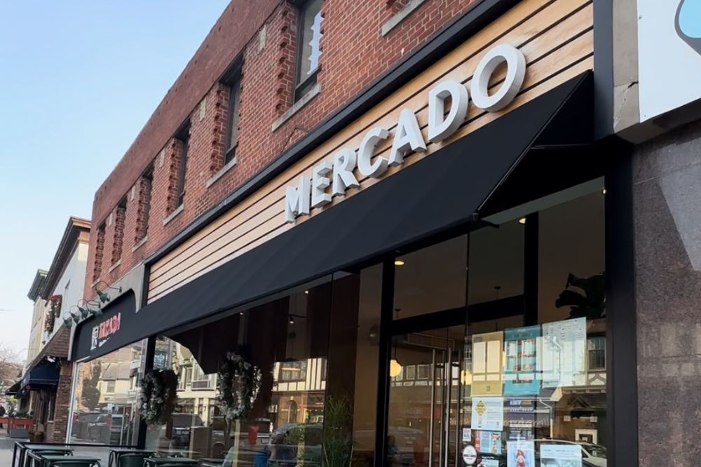 Mercado’s wood-fronted storefront and large windows on Valley Road