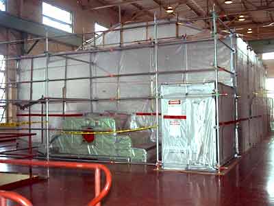 An enclosed industrial work area surrounded by scaffolding, shown in Merico's service photography