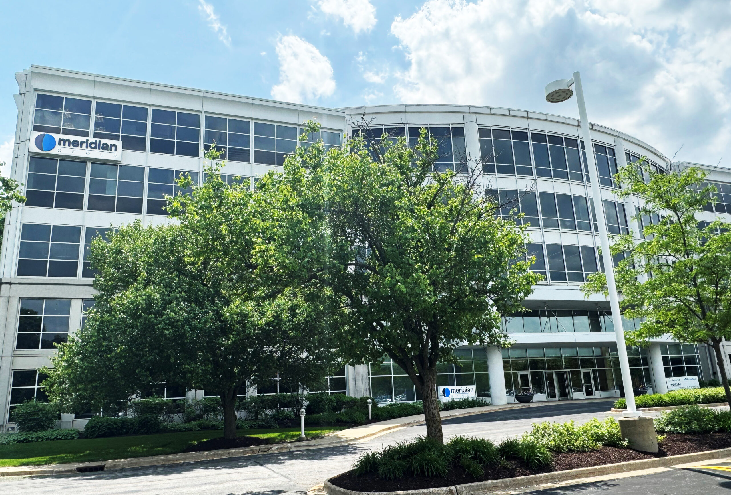 Meridian Group’s Deerfield office building, with trees lining the entrance