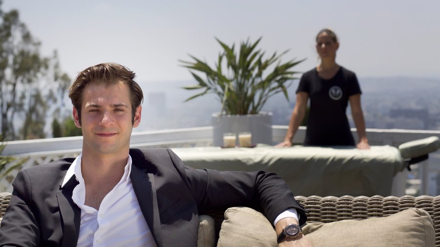 Merlin Kauffman seated on a terrace with a Soothe professional and portable table behind him