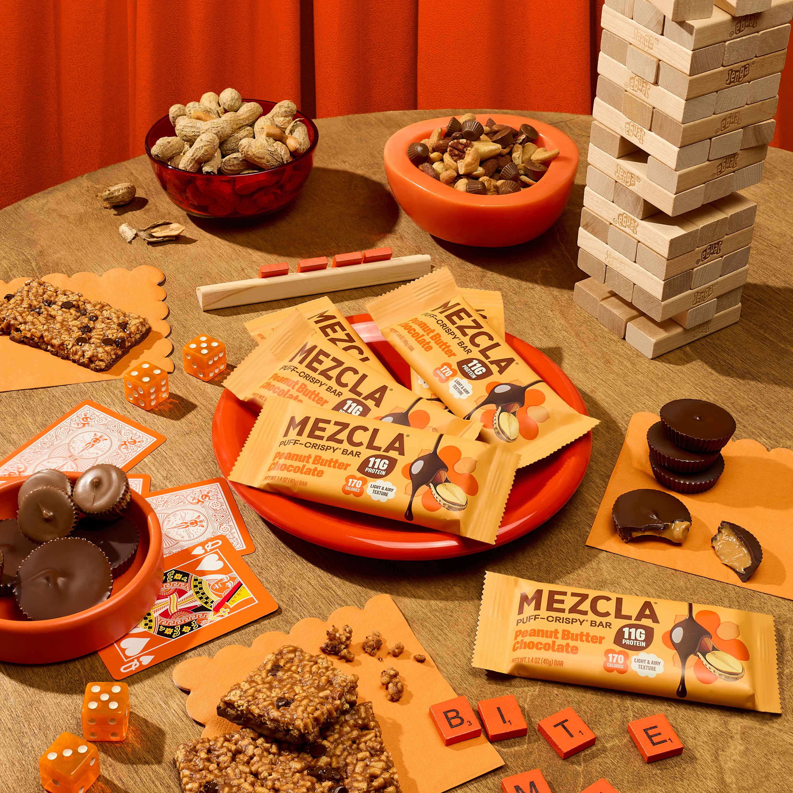 Mezcla wrapped protein bars and snack ingredients arranged on a wooden table