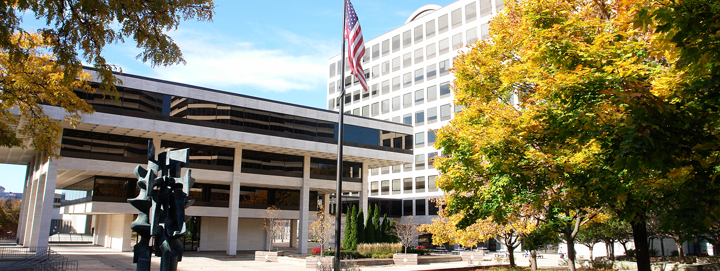 MGIC headquarters in Milwaukee, framed by autumn trees