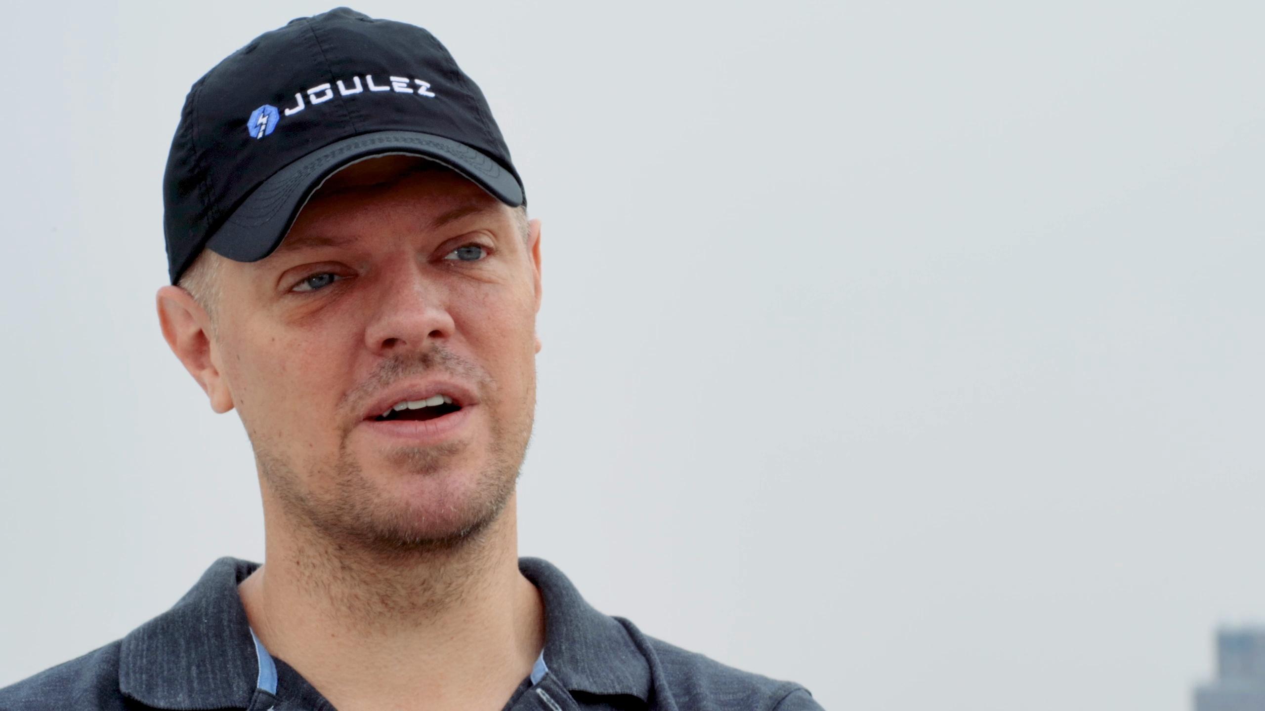 Micah Bergdale wearing a Joulez cap during a filmed interview.