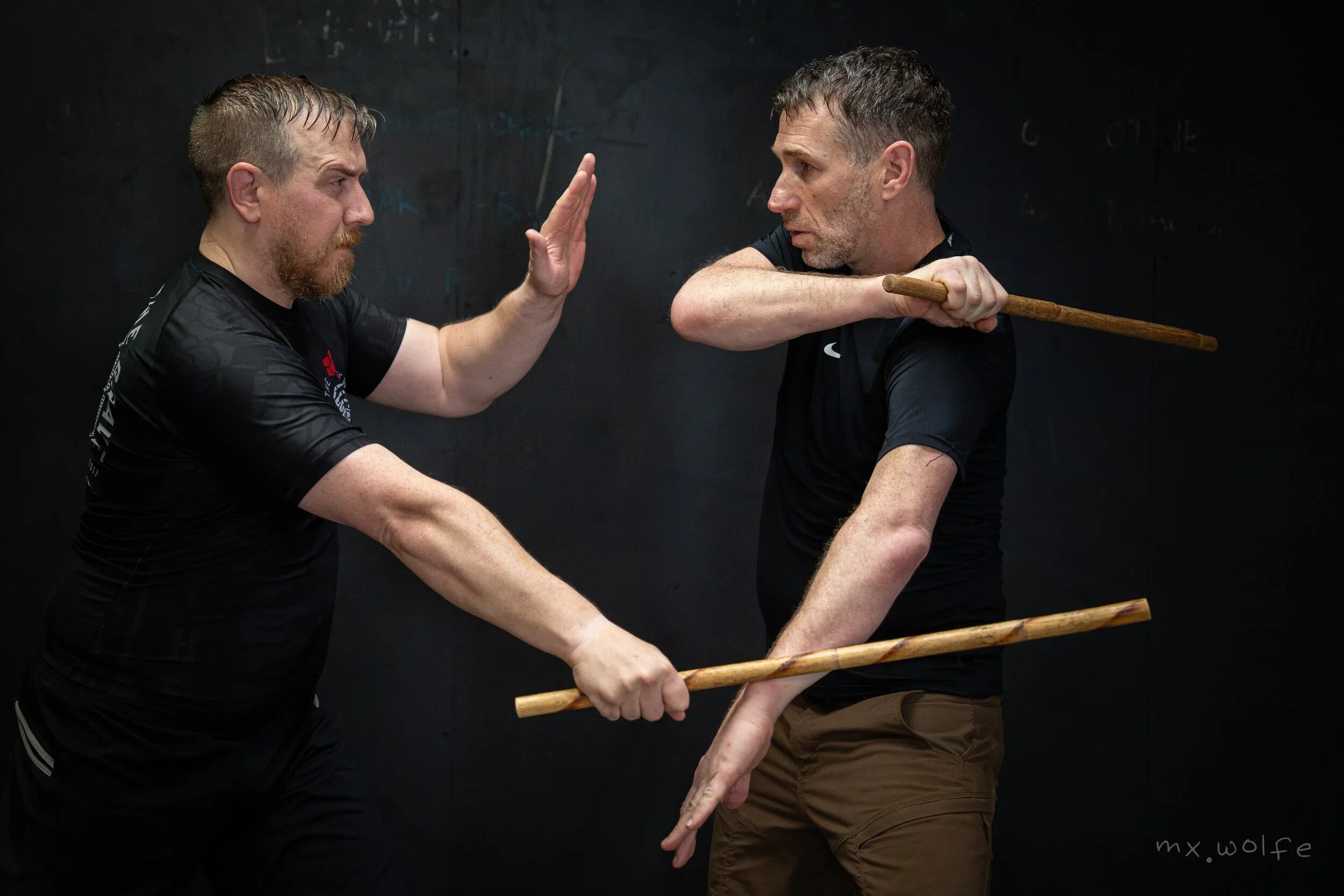 Micha Hershman and a training partner practice stick defense at Forge Krav Maga