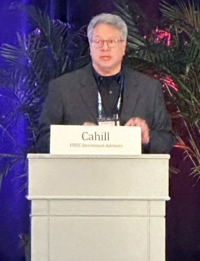 Michael Cahill speaking behind an HREC Investment Advisors podium at the 2025 LIIC presentation