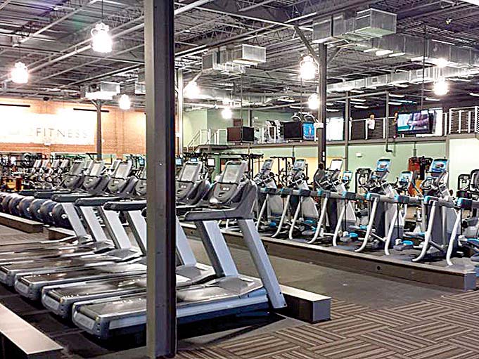 Rows of exercise equipment inside an O2 Fitness club, photographed for the 2014 interview