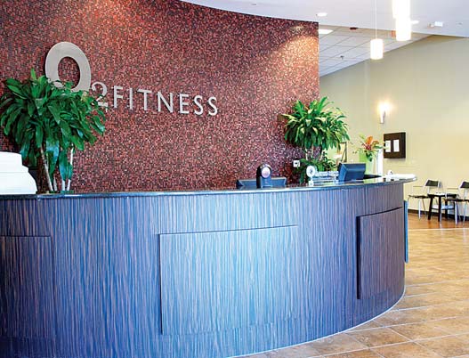 Curved reception desk and seating inside the O2 Fitness Brennan Station lobby