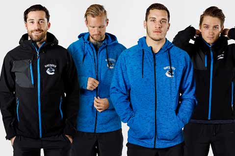 Four Vancouver Canucks players modeling black and blue Stormtech team apparel