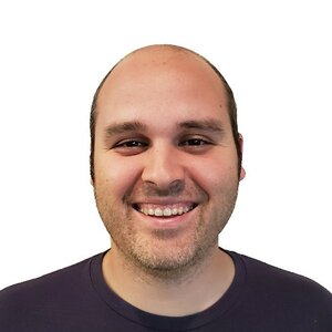 Michael Darmousseh smiling in a public professional portrait