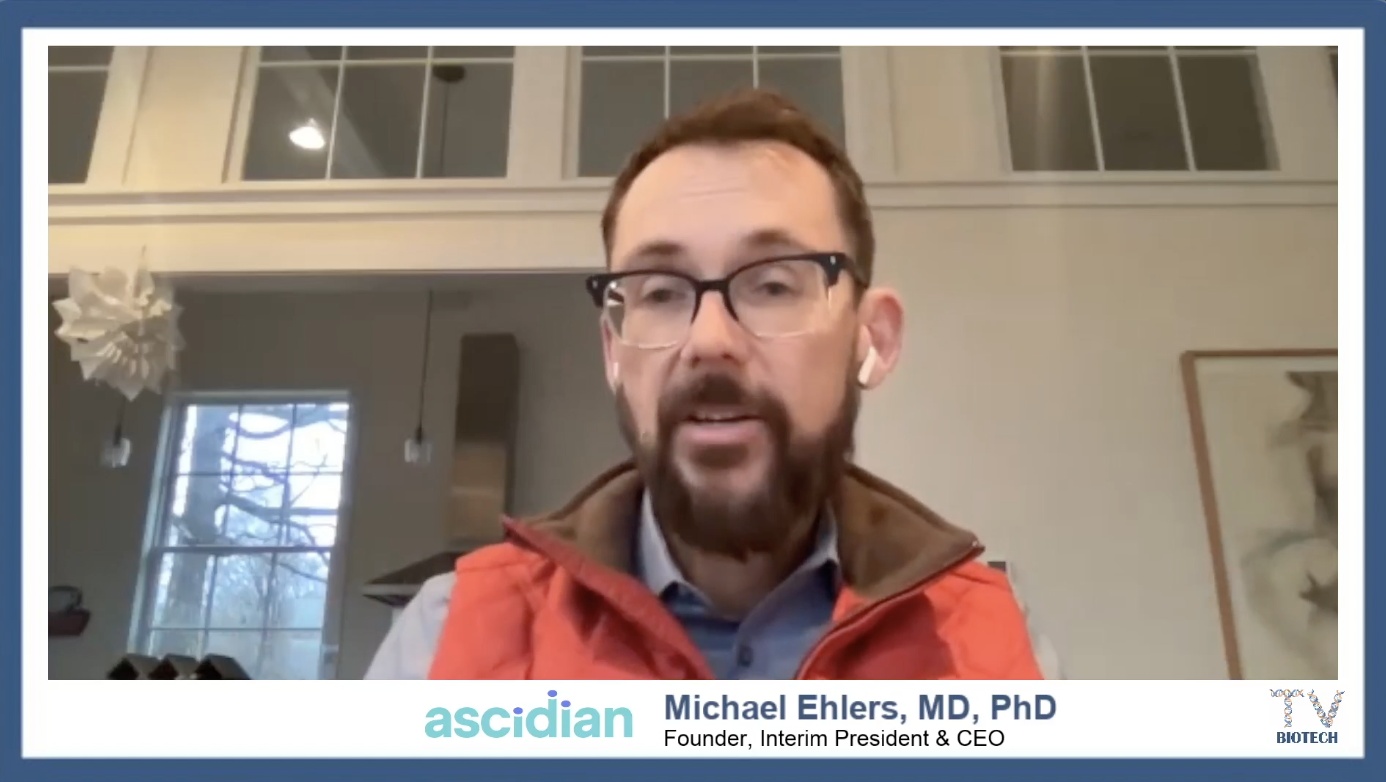 Michael Ehlers speaking in a January 2024 BiotechTV interview, wearing glasses and an orange vest.