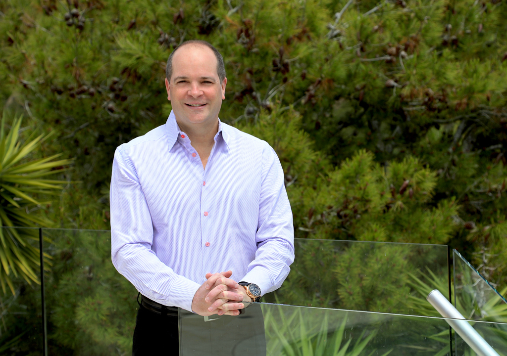 Michael Mick Farrell standing outdoors beside a glass railing