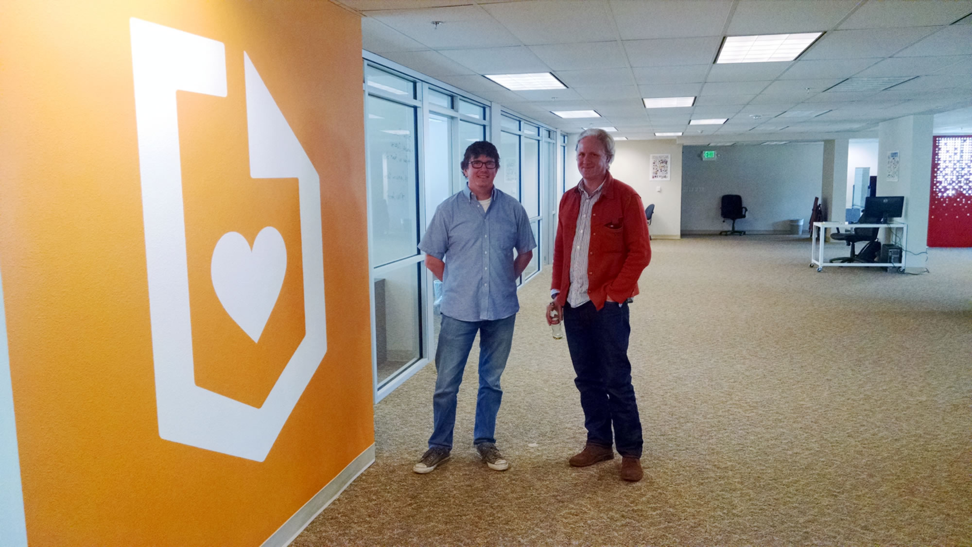 John Brownell and Michael FitzGerald standing in Submittable’s open office in Missoula
