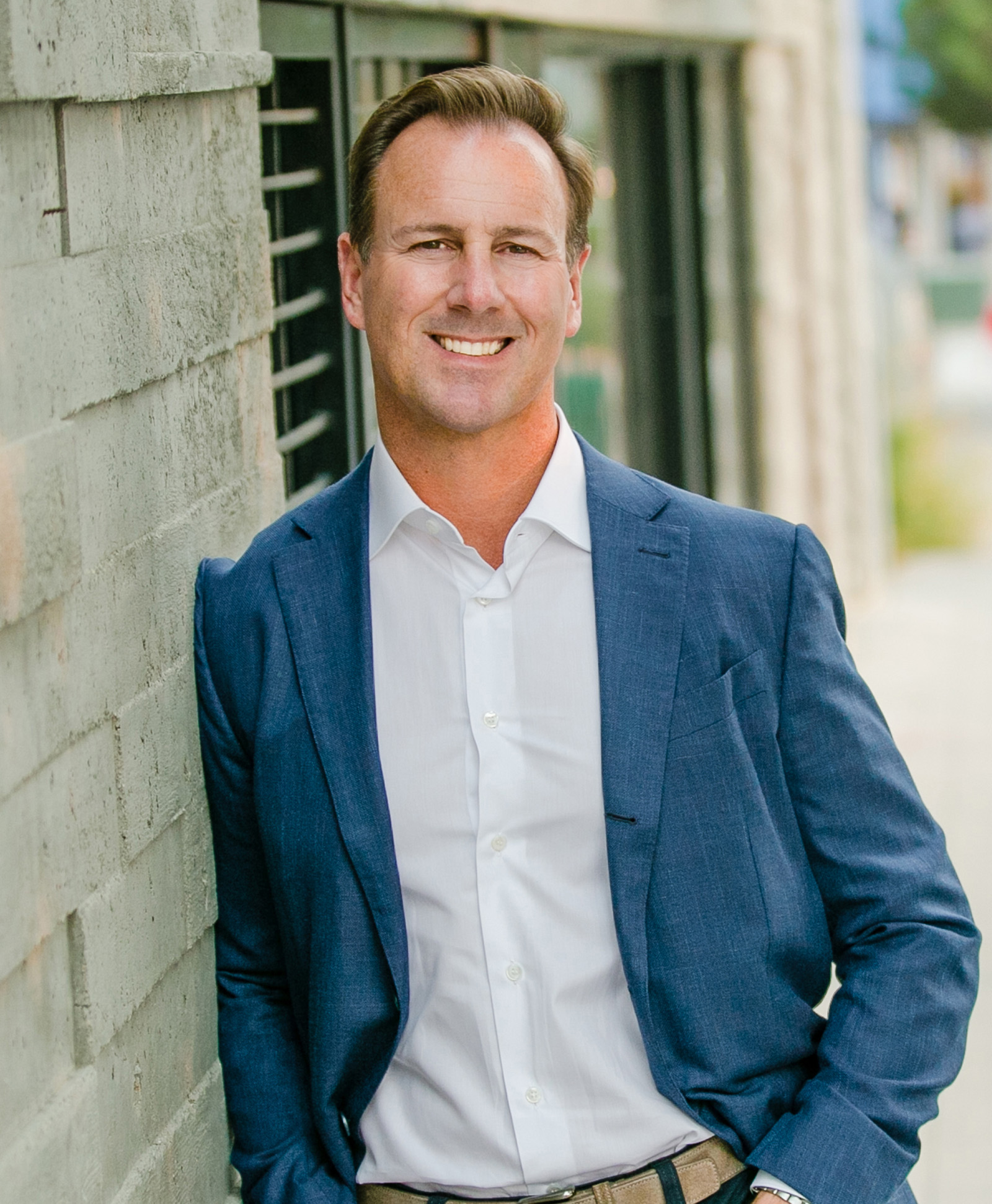 Michael Gianni standing beside a building in an MD7 press photograph