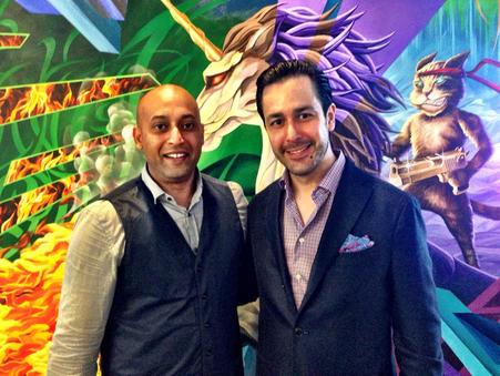Sharad Khare, left, with Michael Gokturk, right, in front of a colourful mural