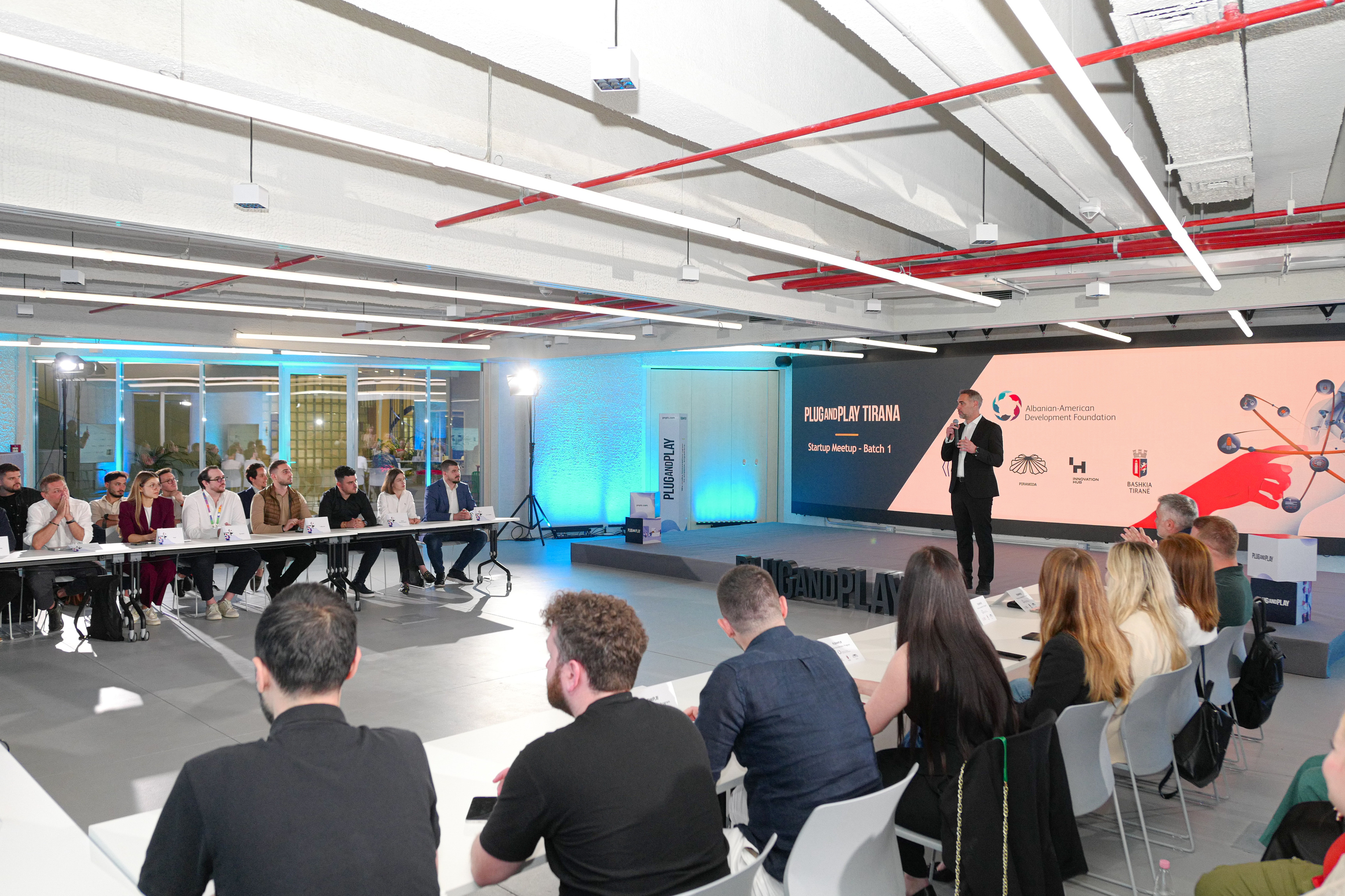 Startup participants seated around a presentation at the Innovation Hub in Tirana
