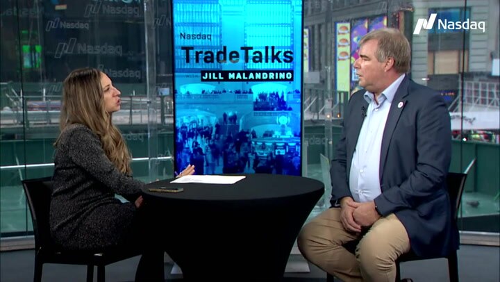 Michael Holdmann speaking with Jill Malandrino at the Nasdaq MarketSite in 2022