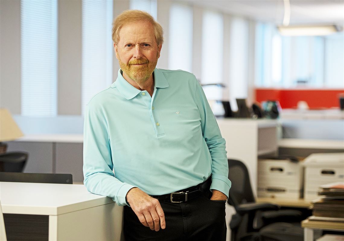 Michael Brunner leaning against a desk in the agency’s open office