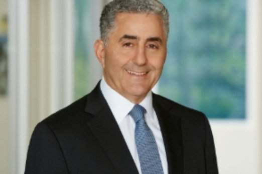 Michael Kasbar smiling in a suit in a World Fuel press photograph