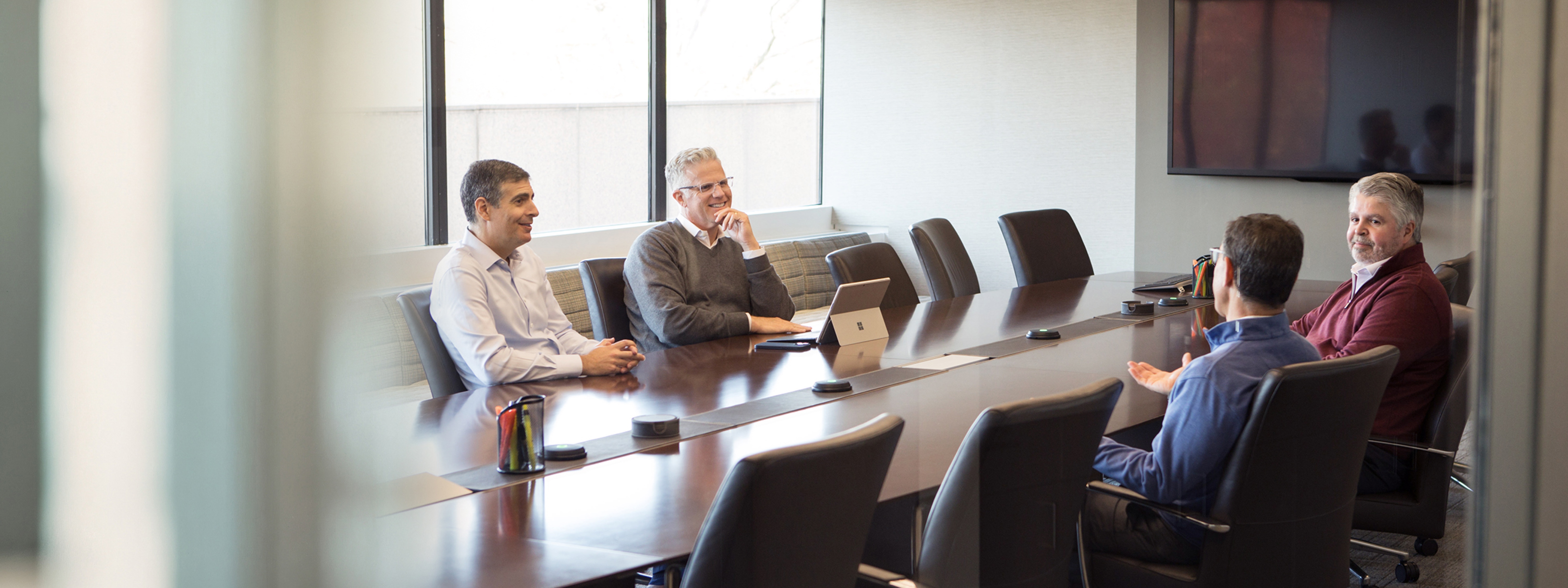 Littlejohn colleagues in discussion around a conference table