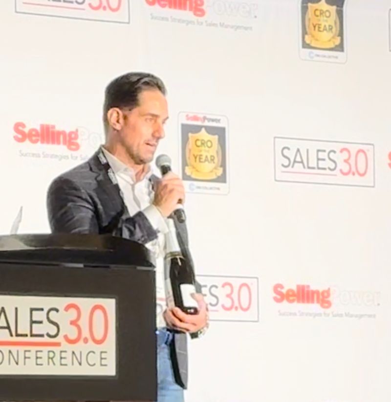 Michael Labate speaking at the Sales 3.0 Conference with his CRO of the Year award