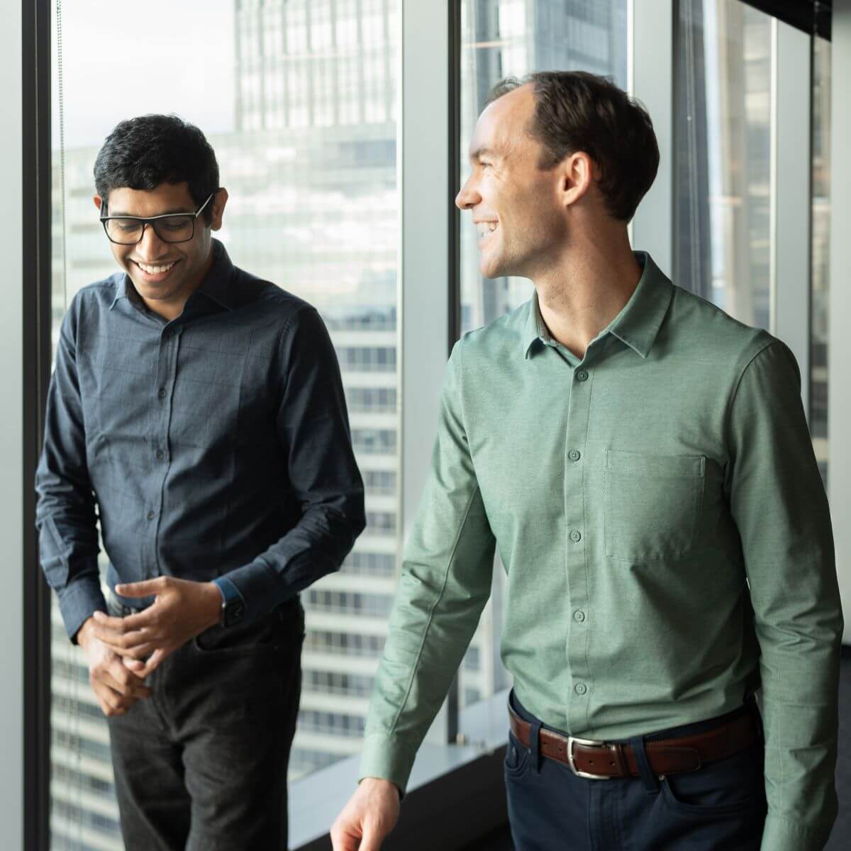 Stackline CTO Raj Ramasamy and CEO Michael Lagoni smiling together beside an office window