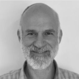 Michael Lewin smiling in a separate black-and-white portrait