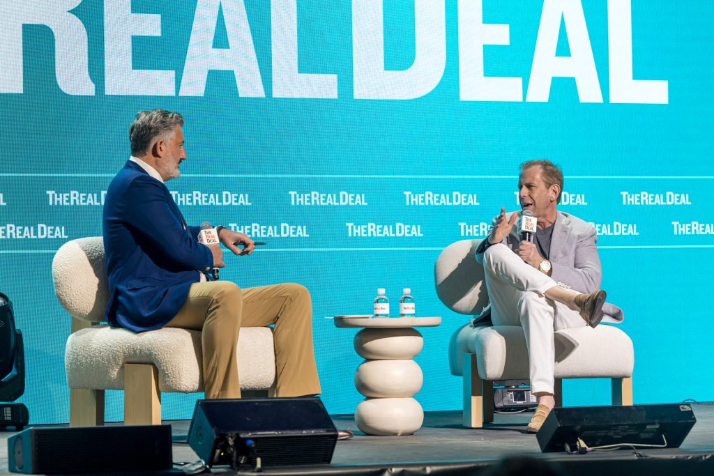 Amir Korangy, left, interviewing Michael Liebowitz onstage in Miami
